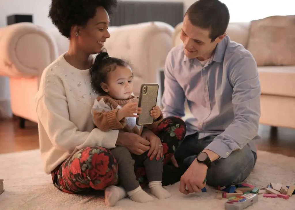 Are Robots Cheaper Than Having Kids: Family with toddler using tablet device