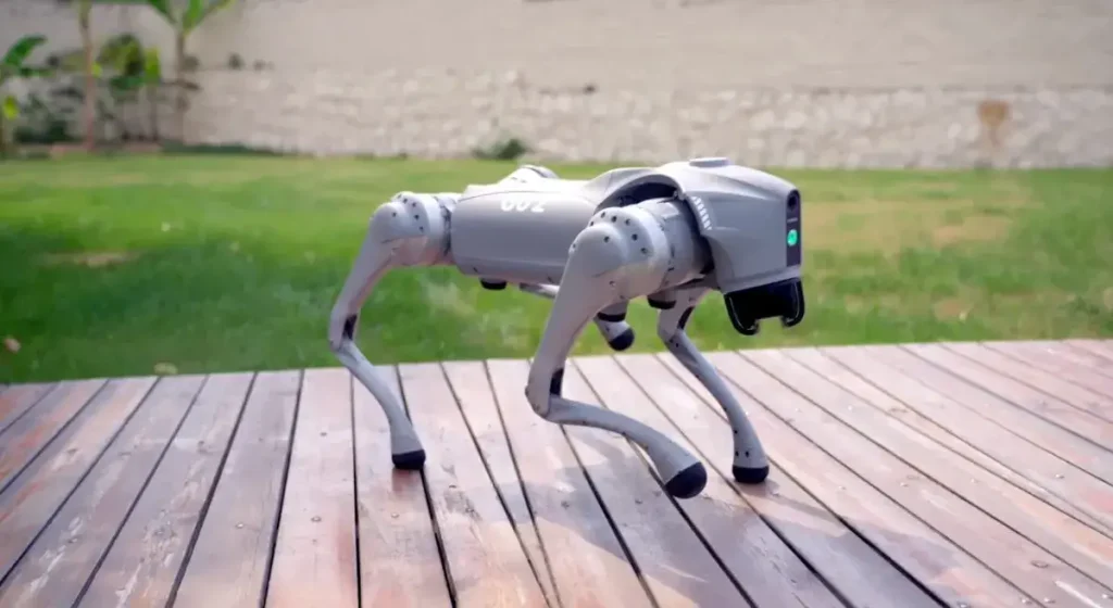 Unitree Go2 quadruped robot dog standing on a backyard deck